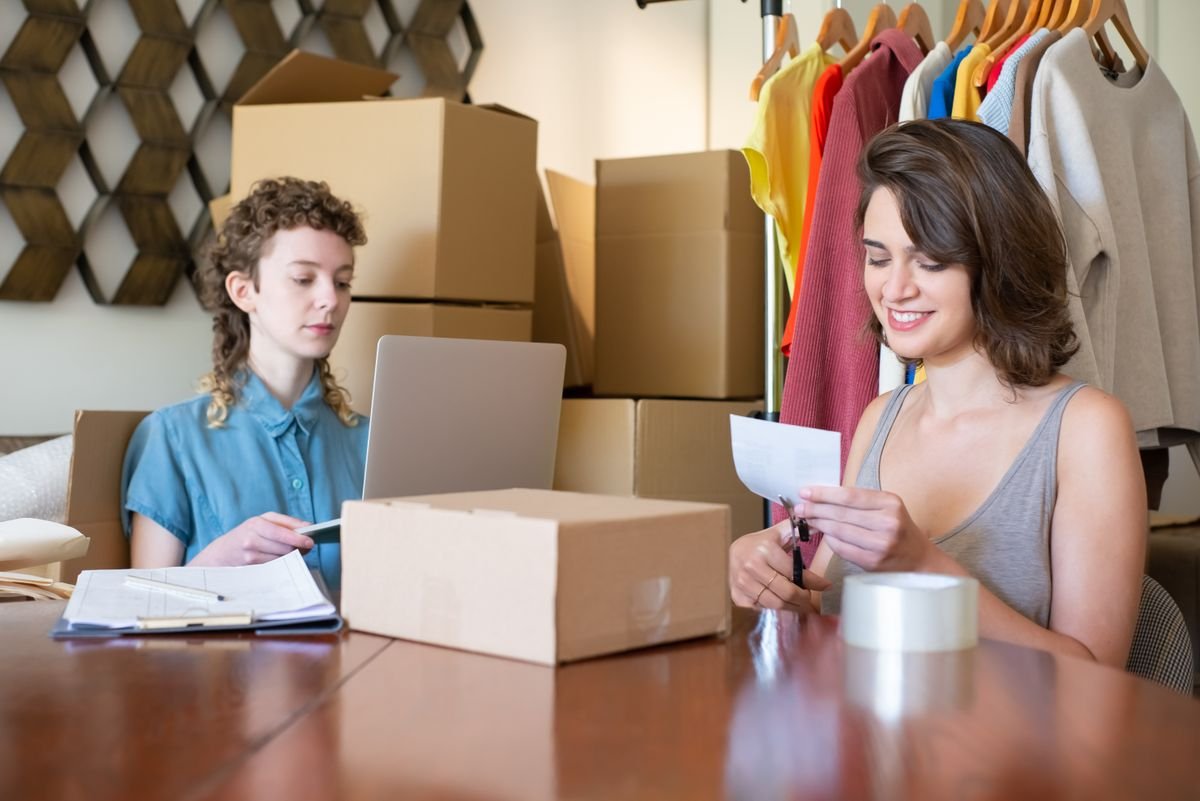 Online store owners working with a laptop and parcels