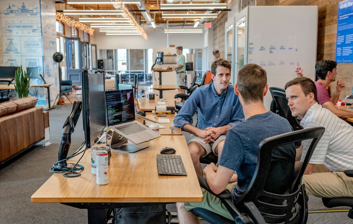 Team working together at a shared desk during a scoping session